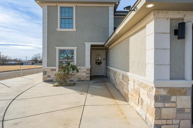a view of a balcony with chairs and potted plants