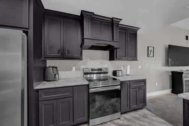 a kitchen with a sink and a stove top oven