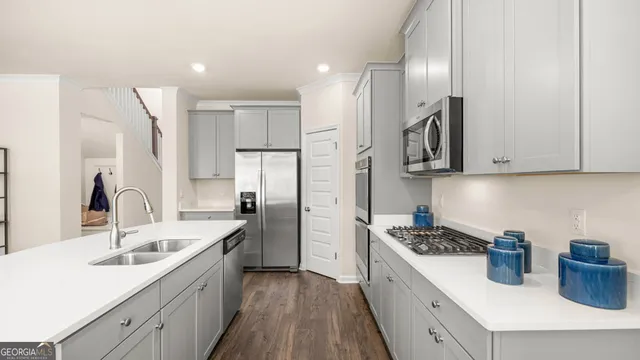 a kitchen with a sink and a refrigerator