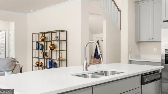 a view of a kitchen with a sink and a living room