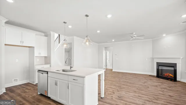 a open kitchen with a sink and refrigerator
