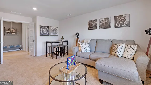 a view of hallway with livingroom and furniture