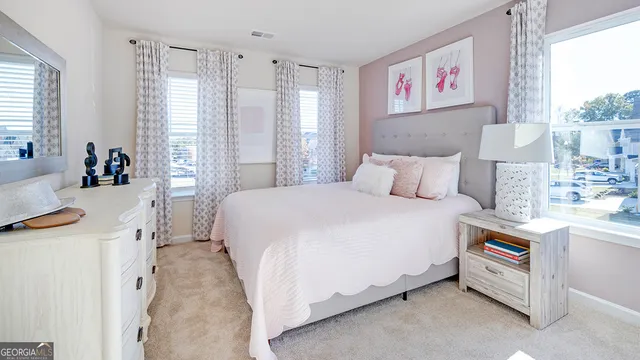 a bedroom with a bed and a painting on the wall