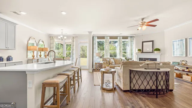 a kitchen with stainless steel appliances a dining table and chairs