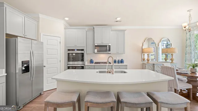 a kitchen with stainless steel appliances a refrigerator stove microwave and cabinets