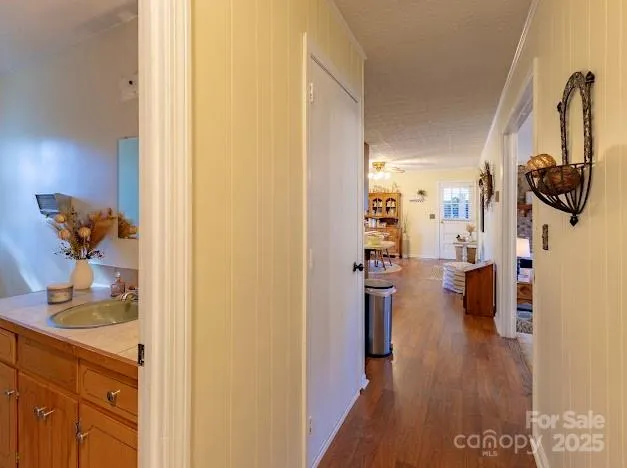 a bedroom with a bed and a flat tv screen on dresser