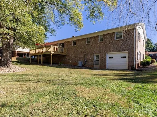 a view of a deck with wooden floor and barbeque oven