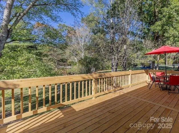 an aerial view of a house with garden space and a car parked on the road