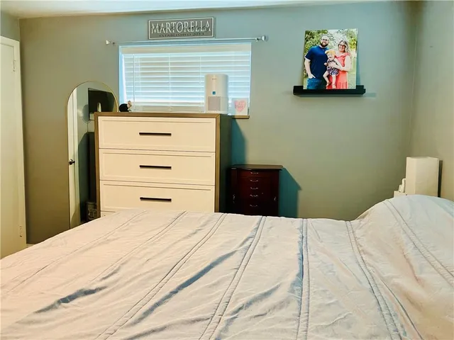 a bedroom with a bed and a cabinets