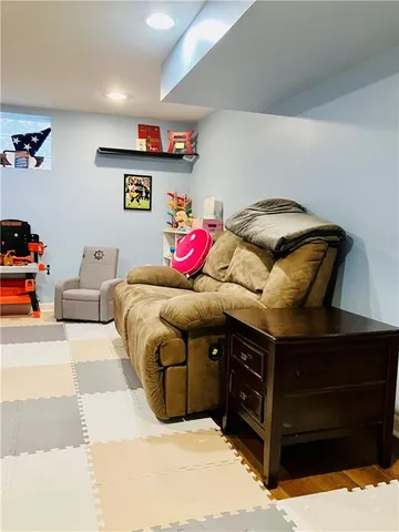 a view of a hallway and a livingroom with furniture