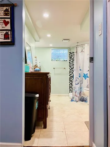 a bathroom with a black and white checkered floor
