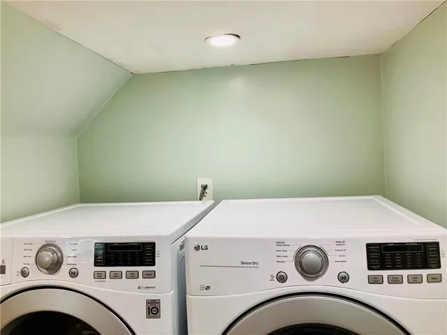 a view of a livingroom with wooden floor and shoes
