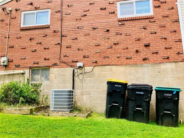 a view of a backyard with wooden fence and a bench