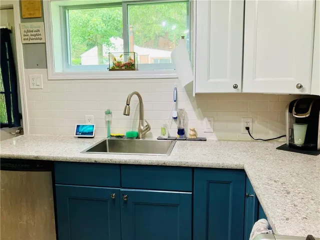 a kitchen with a sink and a window