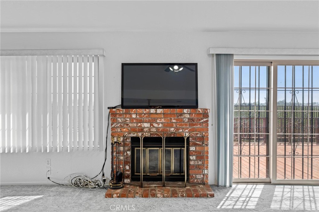 3345 Ave Two Atwater, CA 95301 - Photo 12 of 50 a living room with a fireplace and a flat screen tv