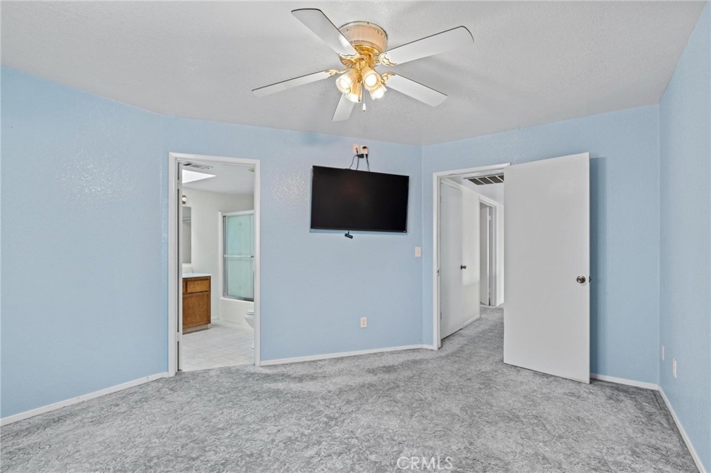 3345 Ave Two Atwater, CA 95301 - Photo 21 of 50 a view of a livingroom with a flat screen tv and a ceiling fan