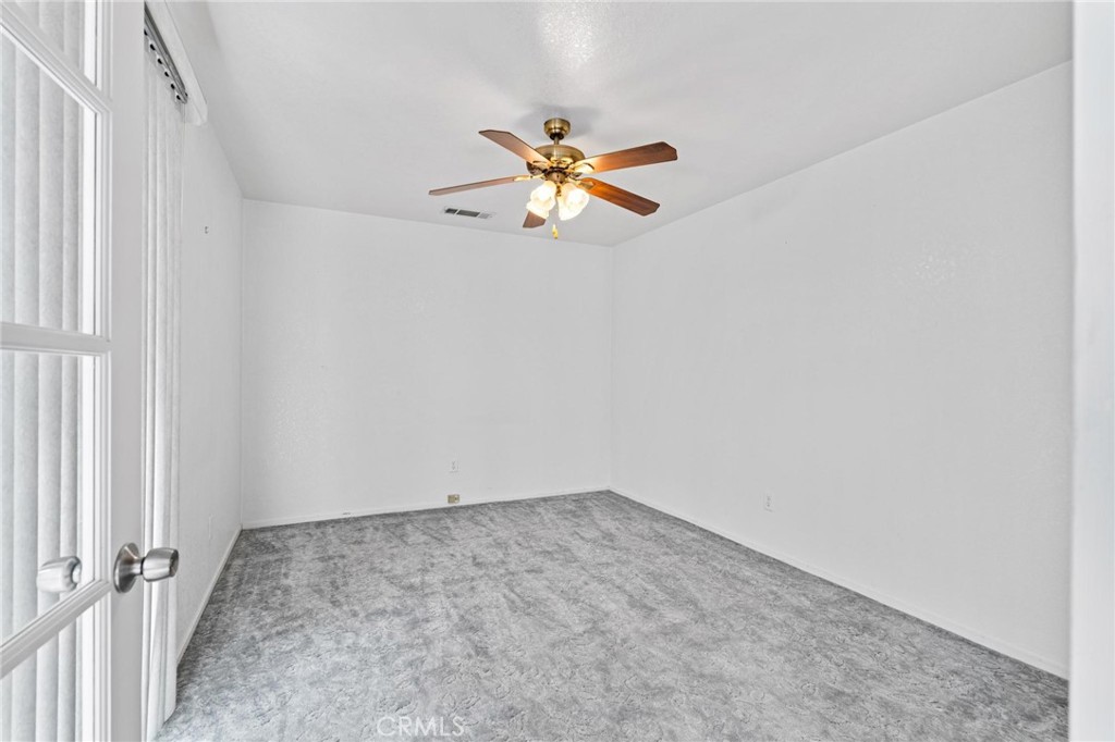 3345 Ave Two Atwater, CA 95301 - Photo 25 of 50 an empty room with a window and a ceiling fan