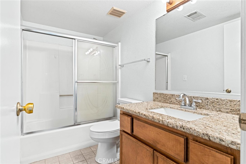 3345 Ave Two Atwater, CA 95301 - Photo 30 of 50 a bathroom with a granite countertop sink toilet and shower