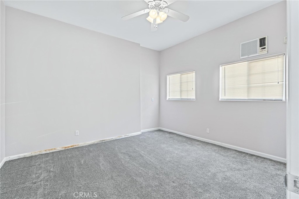 3345 Ave Two Atwater, CA 95301 - Photo 40 of 50 an empty room with a chandelier fan and windows