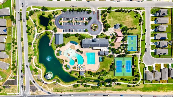 an aerial view of residential houses with outdoor space