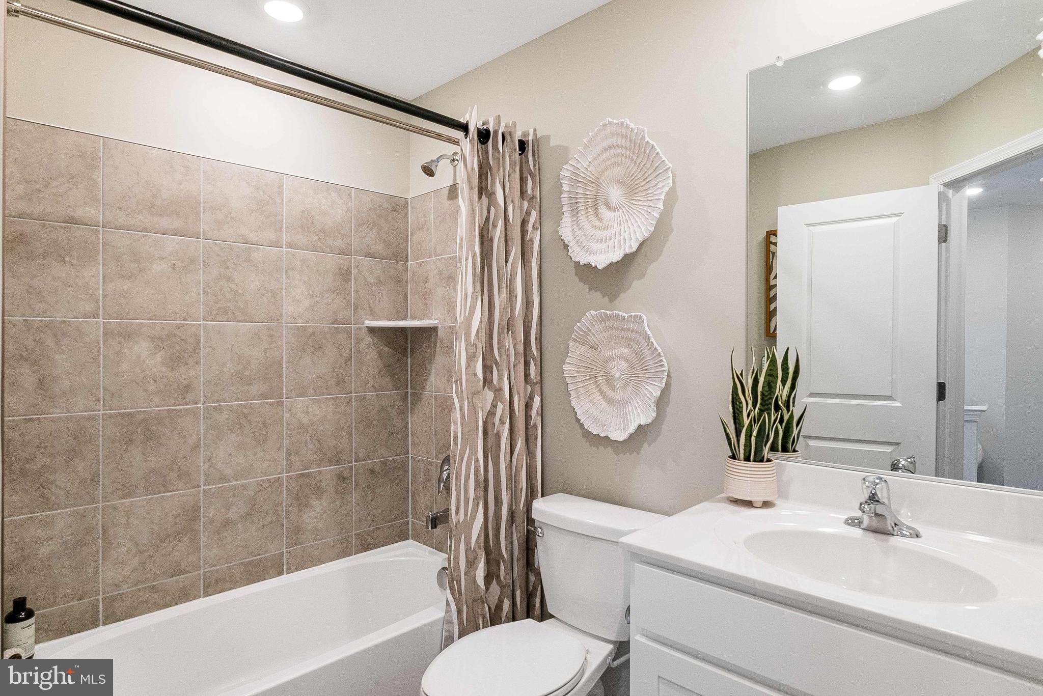 1266 Red Clover Lane Ranson, WV 25438 - Photo 19 of 24 a bathroom with a sink a toilet a mirror and shower