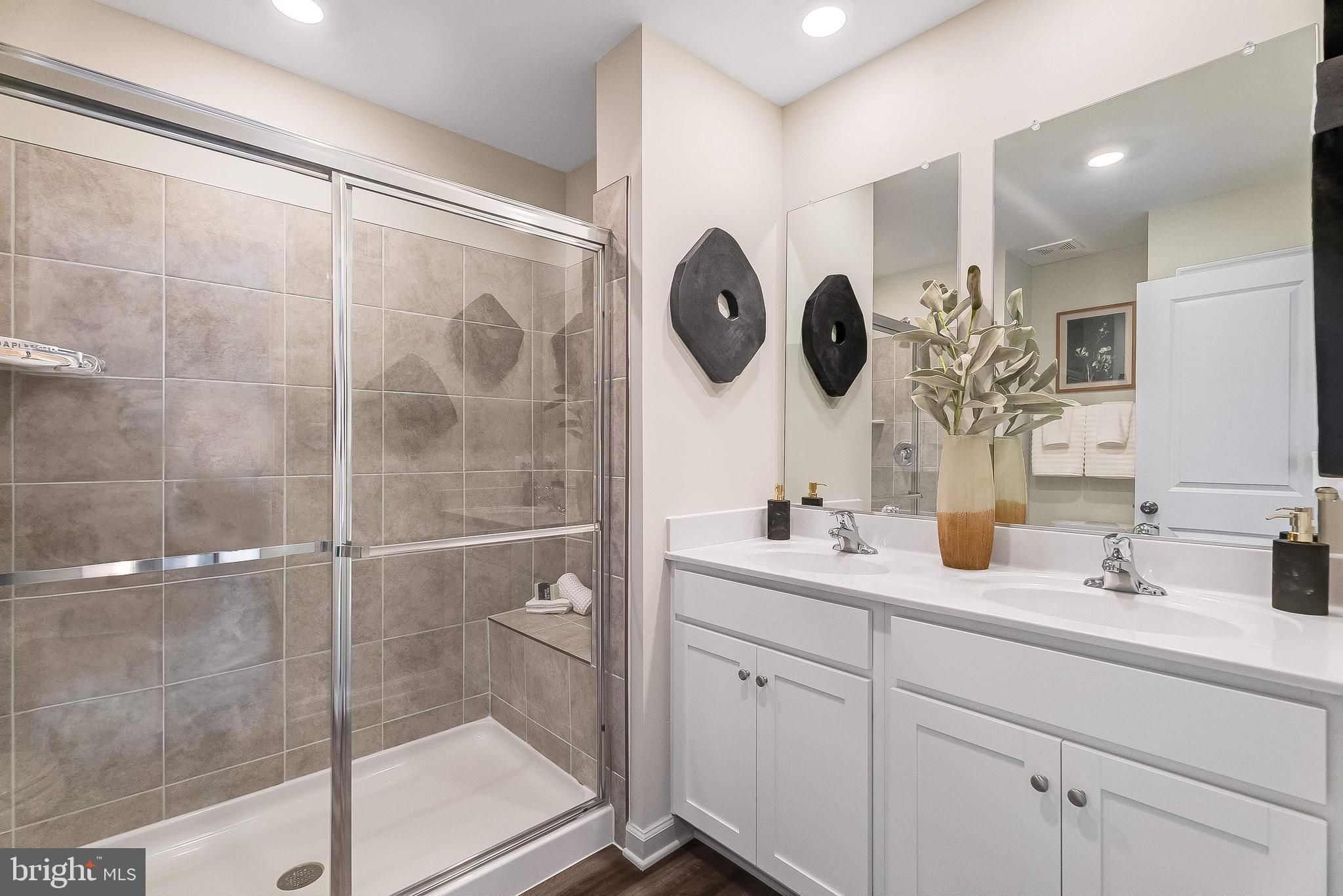 1266 Red Clover Lane Ranson, WV 25438 - Photo 24 of 24 a bathroom with a double vanity sink mirror and shower