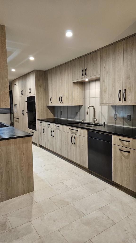 375 West I Street Encinitas, CA 92024 - Photo 10 of 65 a kitchen with stainless steel appliances granite countertop a sink a stove and cabinets