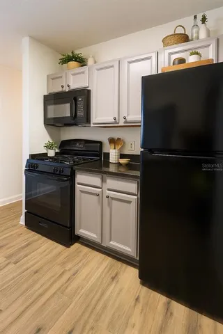 a kitchen with stainless steel appliances a refrigerator stove and microwave