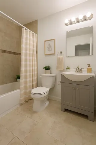 a bathroom with a double vanity sink toilet and shower
