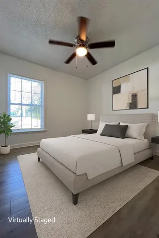 a bedroom with a large bed and a large window