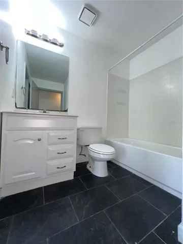 a bathroom with a sink toilet a mirror and vanity