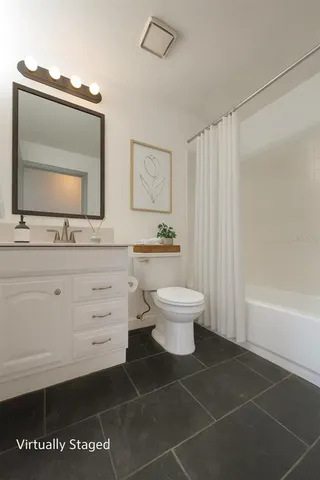 a bathroom with a toilet a sink and a mirror