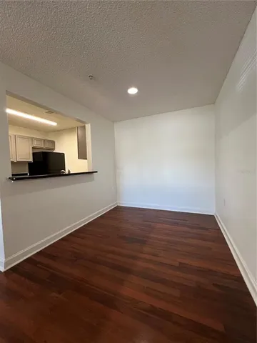 a view of a room with wooden floor and window