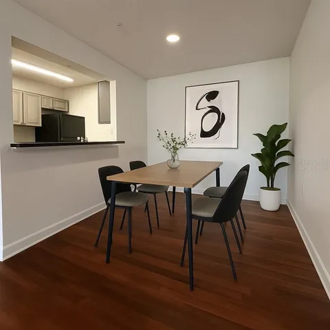 a view of a dining room with furniture and wooden floor