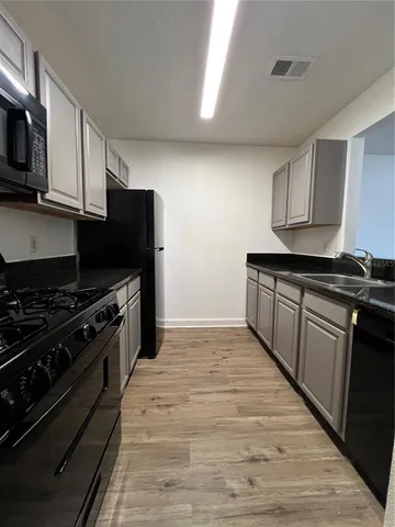 a kitchen with stainless steel appliances granite countertop a stove and a refrigerator