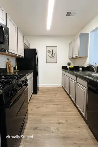 a kitchen with stainless steel appliances granite countertop a stove and a refrigerator
