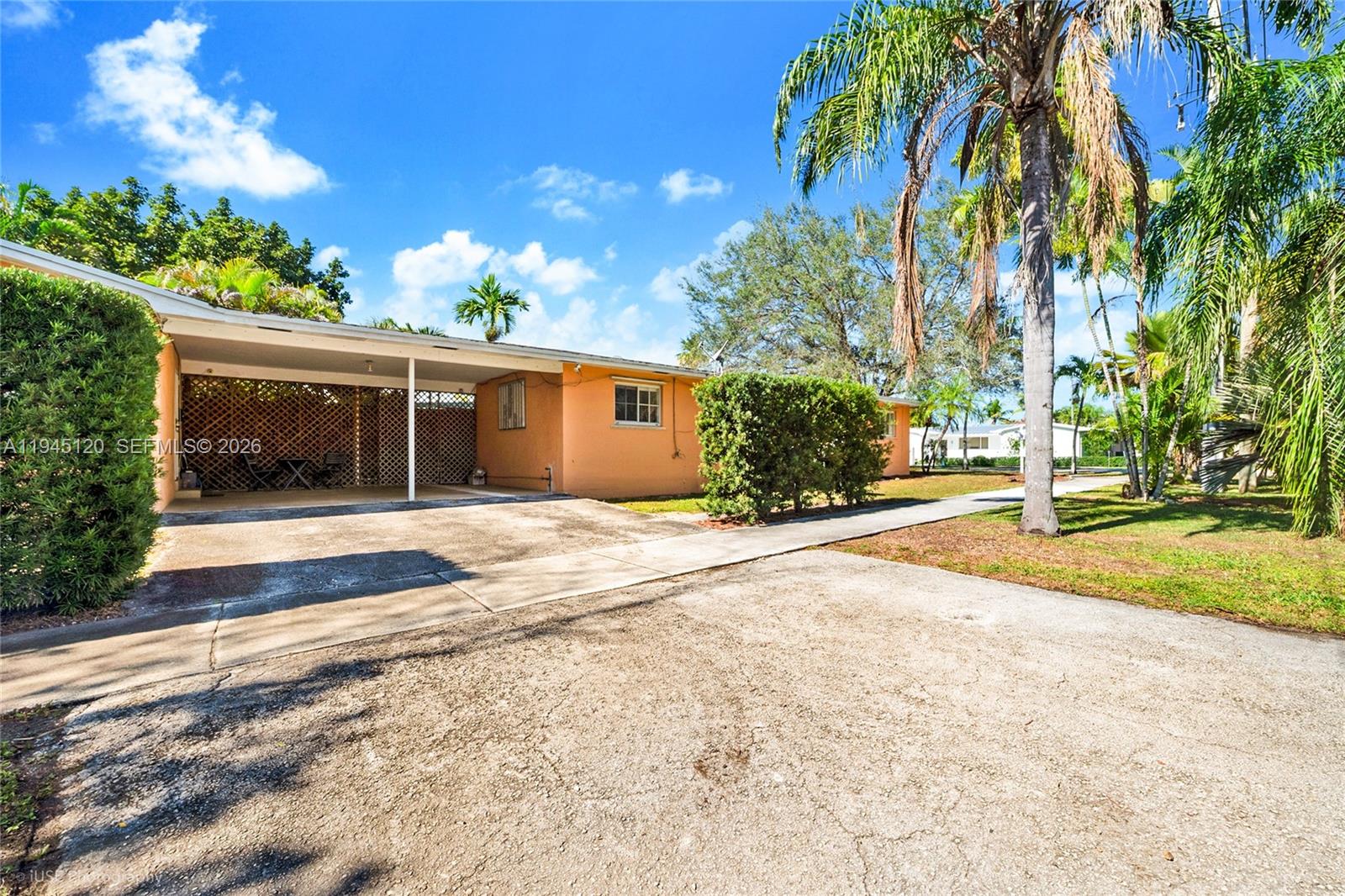 5700 Southwest 45th Terrace Miami, FL 33155 - Photo 14 of 15 a view of a house with a yard and potted plants