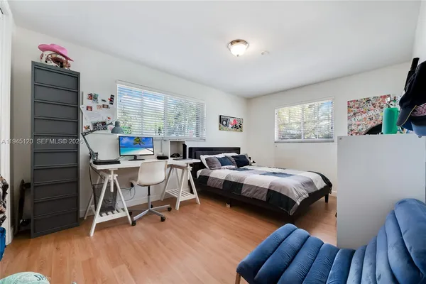 a bedroom with furniture and a wooden floor