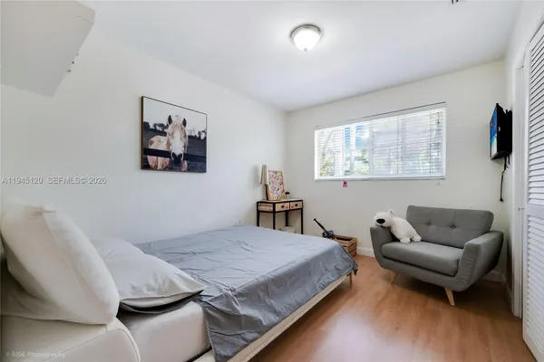 a bedroom with furniture and a wooden floor