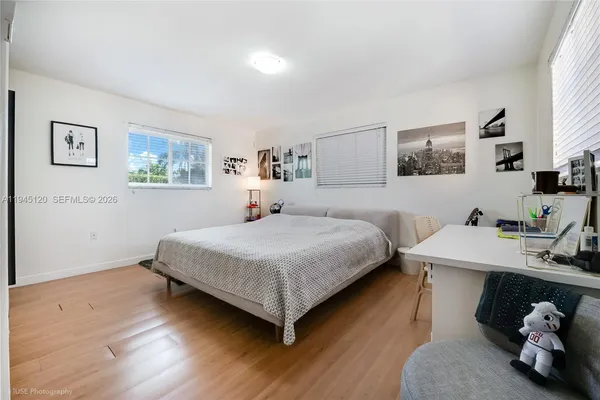 a bedroom with a bed and a desk