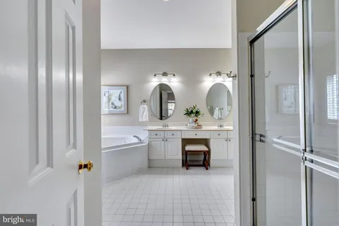 a bathroom with a sink a toilet a mirror a vanity and shower