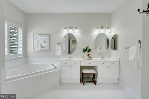 a bathroom with a double vanity sink toilet mirror and shower