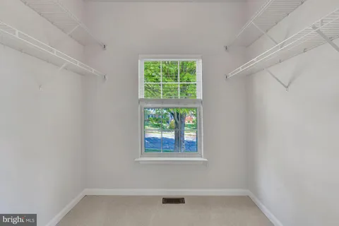 a view of a hallway view with wooden floor and staircase