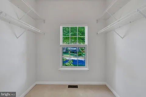 a view of an empty room with wooden walls