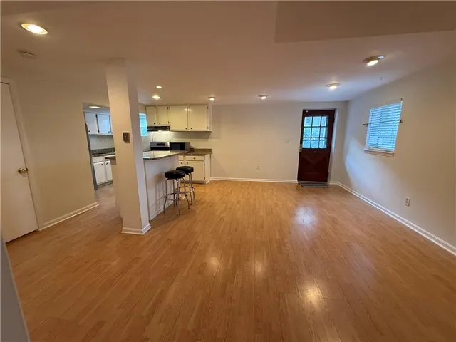 a view of kitchen with cabinets and wooden floor
