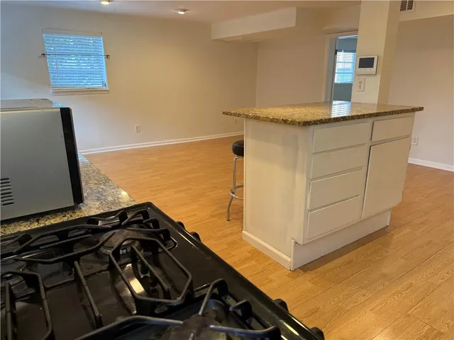 a close view of a sink a stove and a mirror