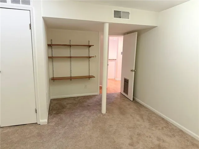 a view of an empty room with a closet