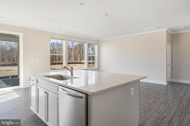 a kitchen with stainless steel appliances granite countertop a sink and a refrigerator