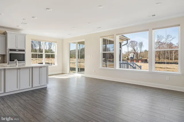 a view of kitchen with granite countertop window and wooden floor