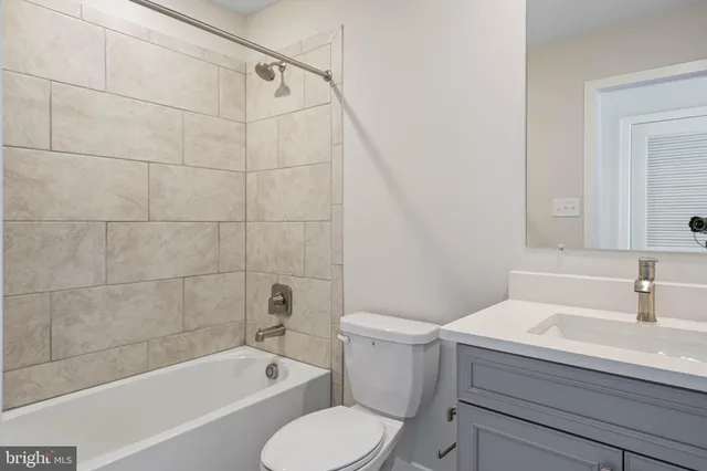 a bathroom with a sink a toilet and bathtub